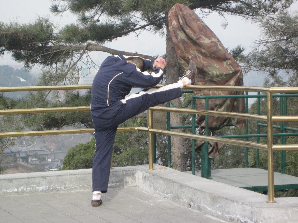 Man stretching as part of his morning Tai chi routine, 