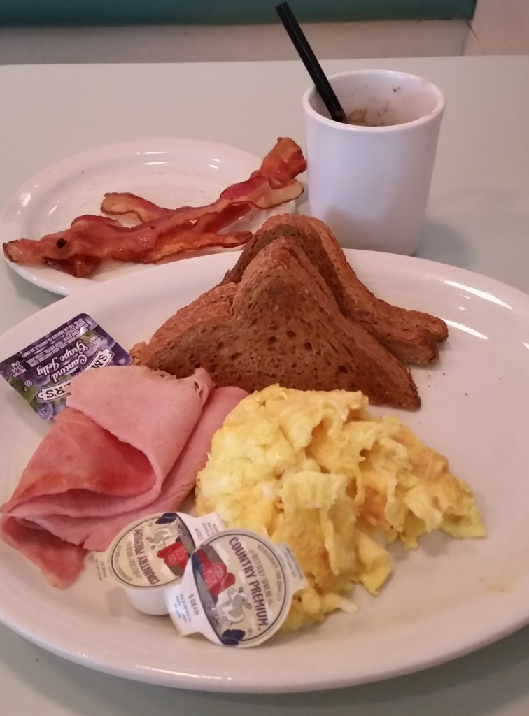 Scrambled eggs and ham with bacon on the side and whole wheat toast. The drink was hot chocolate. Grade C