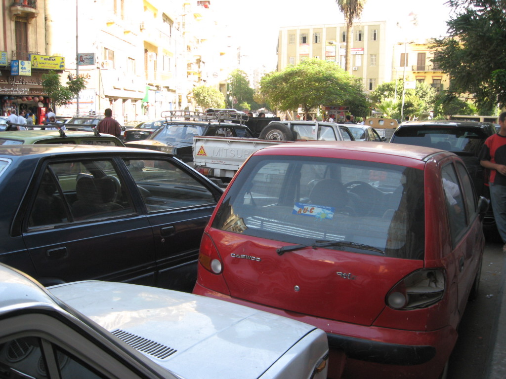 Heavily trafficked street in Cairo, filled with licensed and unlicensed taxis and buses,