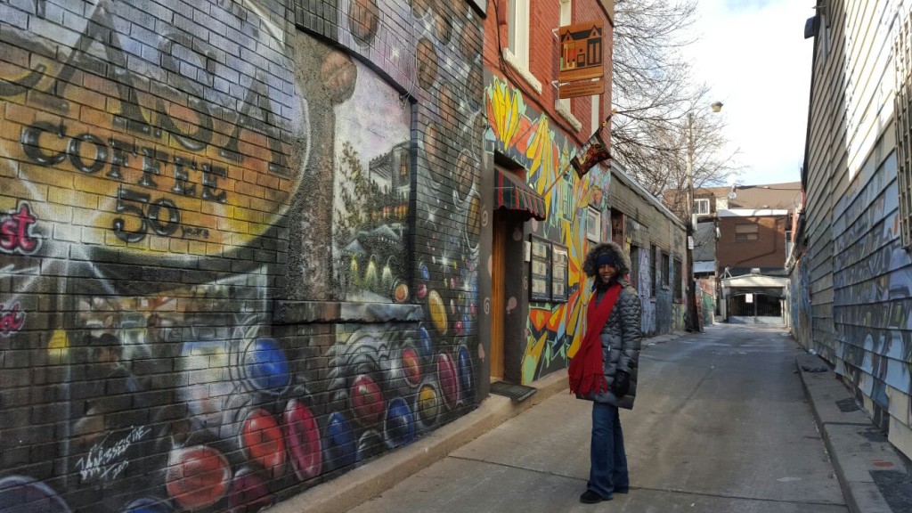 An alley in Kensington Market with walls that looked like an outdoor art gallery